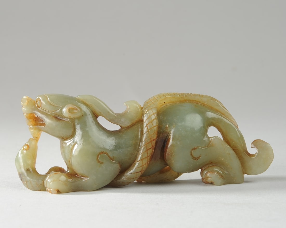 Chinese Green Jade Carving: Mythical beast and snake. Approx. 4 1/2" x 1 3/4" x 1". Seamless shipping is available through LiveAuctioneers at checkout, but you are welcome to arrange your own shipping if you prefer—many bidder