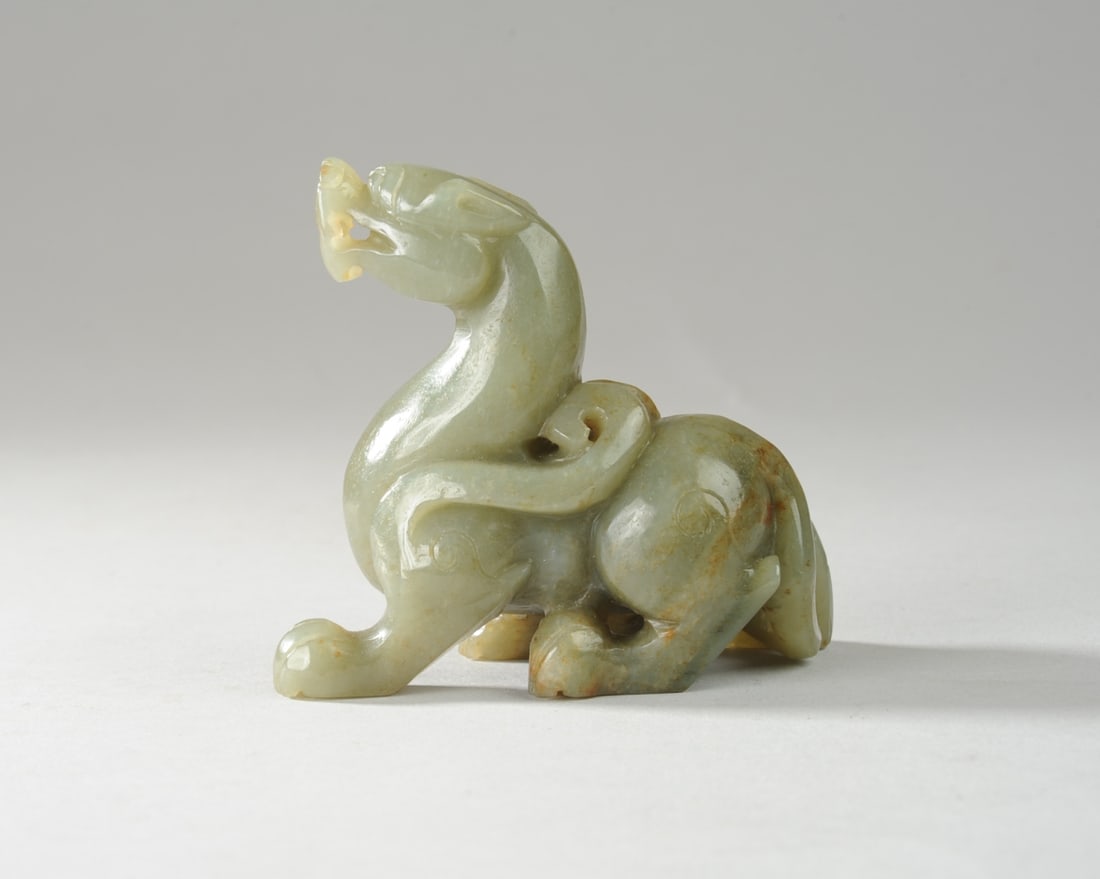 Chinese Green Jade Carving of a Dragon: Approx. 2 7/8" x 3 1/4" x 1 1/2". Seamless shipping is available through LiveAuctioneers at checkout, but you are welcome to arrange your own shipping if you prefer—many bidders find this can be the
