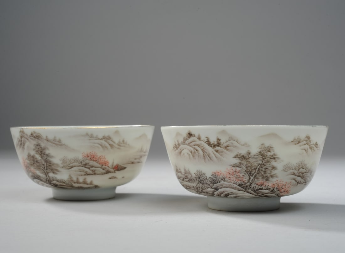 Pair of Chinese Porcelain Cups: With Grisaille landscapes with calligraphy & seal marks, gilded rims. H: approx. 2 1/4". Dia: approx. 4 1/2". Seamless shipping is available through LiveAuctioneers at checkout, but you are welcome to