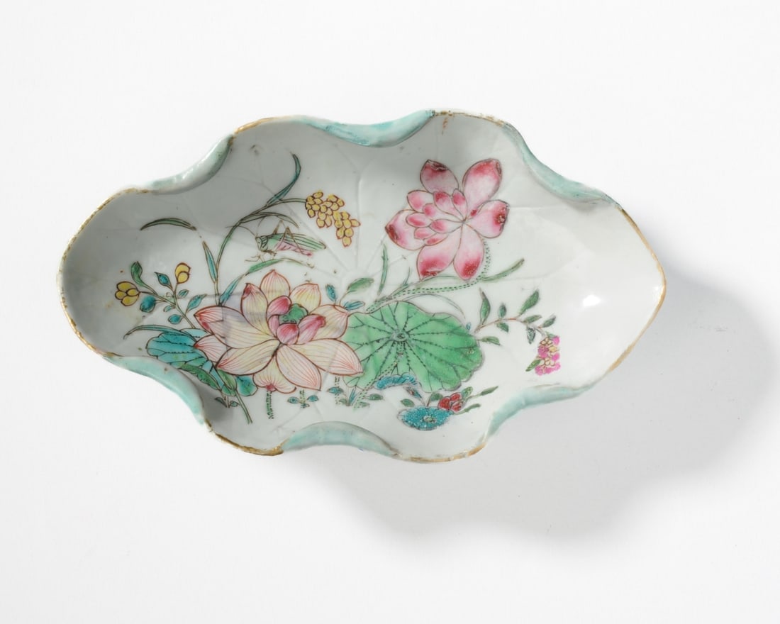 Chinese Famille Rose Lotus Dish, Yongzheng: 18th C. Chinese porcelain tea dish in the form of a lotus leaf, the interior painted with lotus flowers, the exterior with applied flowers, stems and tendrils tied with a blue cord, all in soft bright