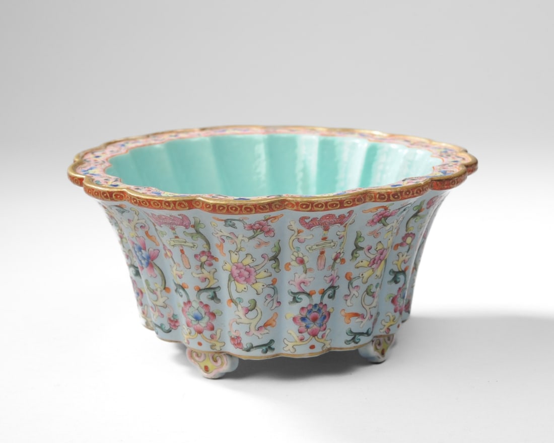 Chinese Famille Rose Lavender Ground Jardiniere: Small round porcelain jardiniere with flat, scalloped rim, convex paneled sides joined to flat bottom on four ruyi-form feet. The sides with scrolling lotus and auspicious pink bats in famille rose en