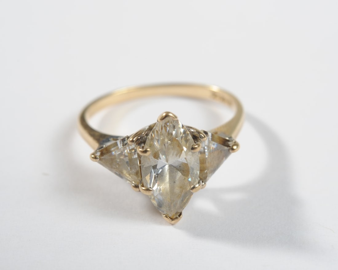 14K Gold Marquise and Trillion Cut CZ Ring: Size 6 1/2. Total weight: approx. 3.3 grams. PLEASE NOTE: First-time buyers of gold or silver may be required to pay by check or bank wire transfer; Credit card payments may not be accepted for these