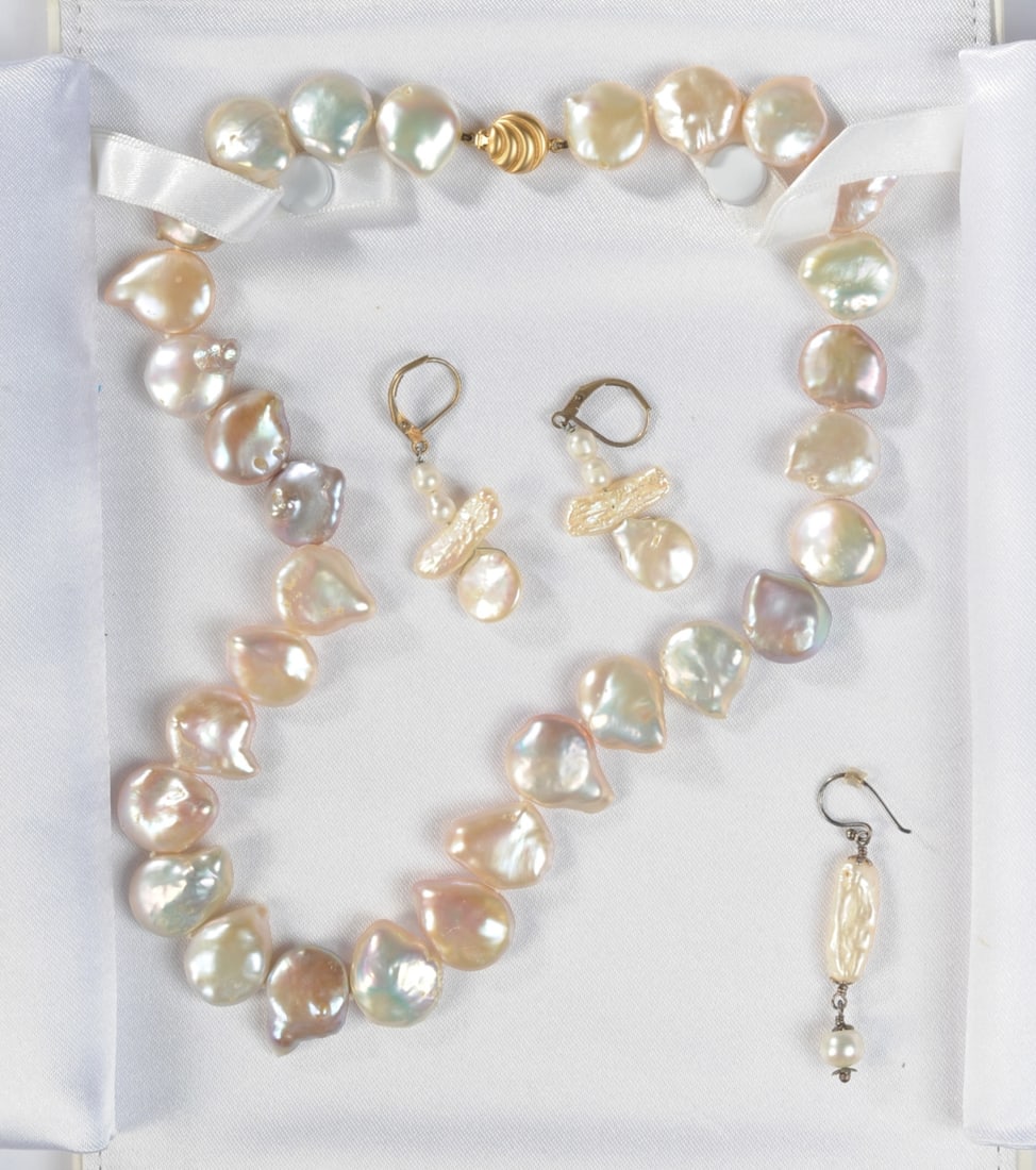 18K Baroque Pearl Necklace with Earrings: Necklace with of irregularly shaped baroque pearls, clasp is gold marked “JKe 750”. Accompanied by a pair of earrings, and a single earring. In case marked Carreras, some damage to case. Neckl