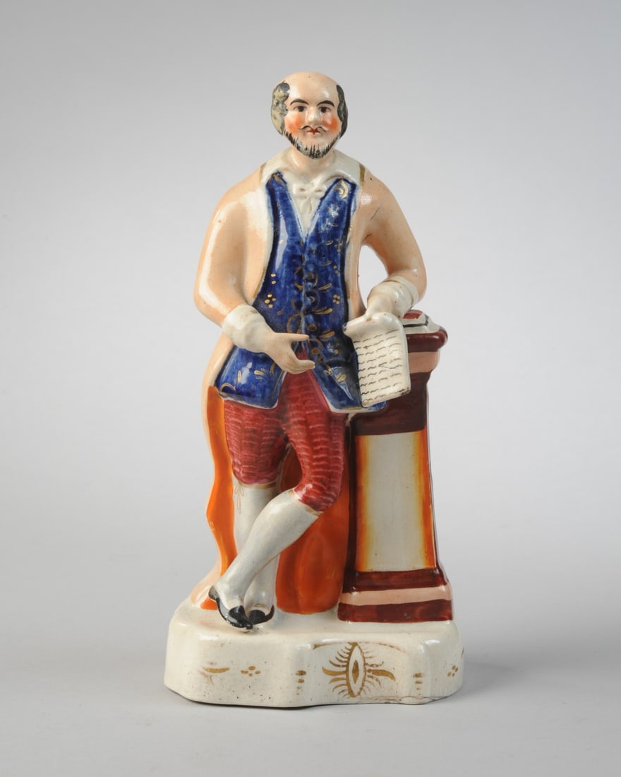 19th C. Staffordshire Shakespeare Figure: Colorfully painted figure of William Shakespeare, elbow resting on column, with manuscript in his hand. Minor losses to the Bard's painted hair. H: approx. 9". W: approx. 4 3/8". D: approx. 3". Our pr