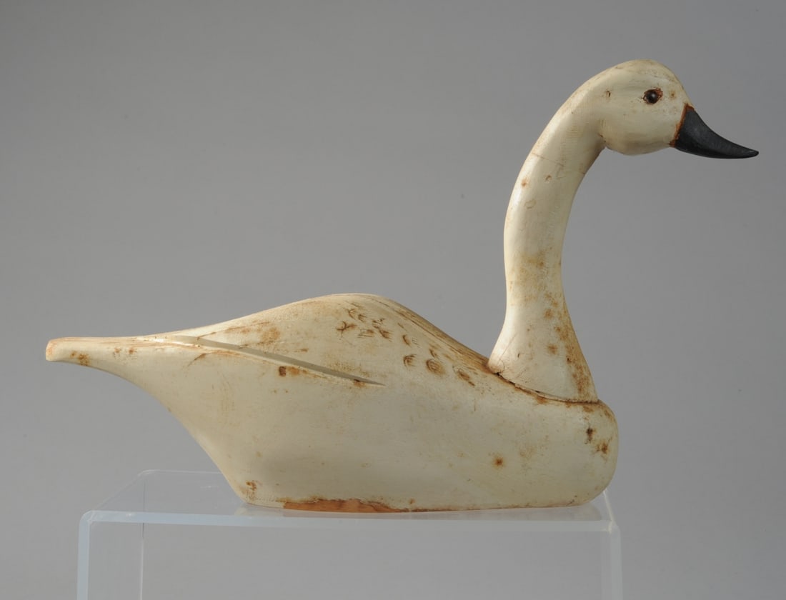 Carved and Painted Wooden Swan: Glass eyes, crack to back, "CT" in red to underside. H: approx. 10 1/2". L: approx. 17". W: approx. 5 1/2". Our primary recommendation is to arrange shipping yourself using Blue Ridge Pack & Ship. Mos
