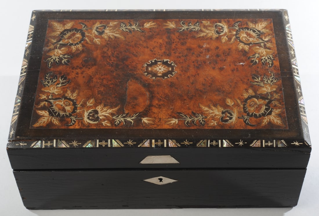 Antique Inlaid Lap Desk: Inlaid burlwood and mother of pearl box which folds out to become a lap desk with red velvet writing surface, pencil tray, and storage compartment. Minor losses, crack, Approx. 13" x 9" x 5" H. Our pr