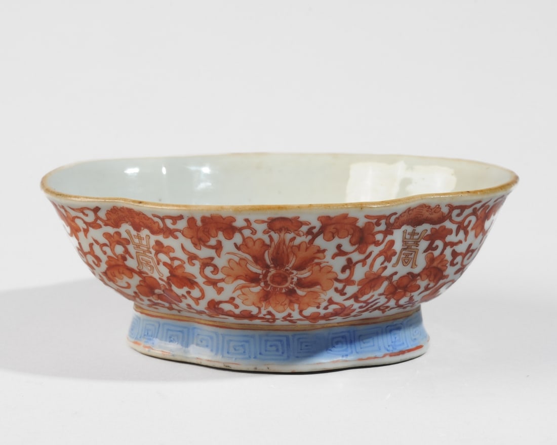 Chinese Porcelain Shou Bowl: Elongated four-lobe bowl on pedestal foot, the sides decorated with lotus scrolls and shou symbols (longevity) in red and gilt, the foot with blue key border. Base with spurious Yongzheng seal script 