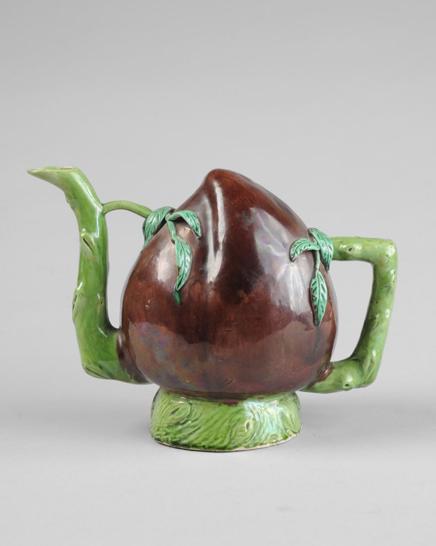 Chinese Peach- Form Cadogan Teapot: Chinese puzzle teapot in the form of a peach, with aubergine glazed fruit and green applied leaves, green glazed handle, base and spout in the form of branches. No chips, cracks or repairs found. Appr