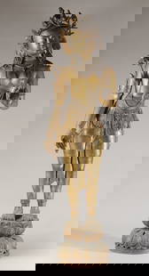 50" Nepalese Brass Alloy Figure of Green Tara: Large mid-20th C. Newar-style Nepalese brass alloy figure of Green Tara, depicted standing on a lotus base and wearing a floral crown. Lotus stalks bloom at each shoulder. Her right hand is held in