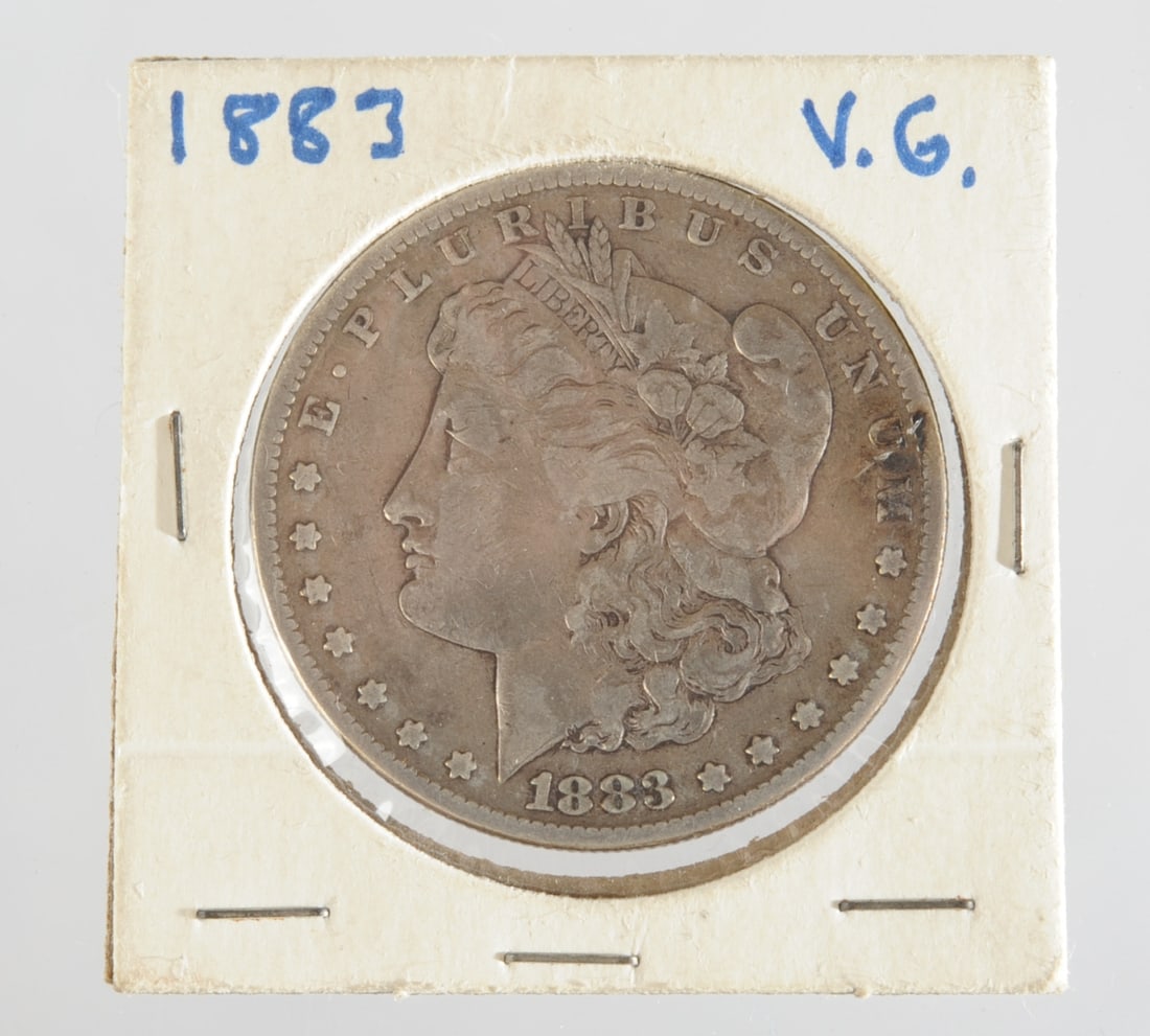 1883 Morgan Silver Dollar: United States Morgan silver dollar dated 1883. Obverse with Liberty head, reverse with eagle and legend United States of America / One Dollar, circulated, no mint mark. Dia: approx. 1 1/2". Our primar