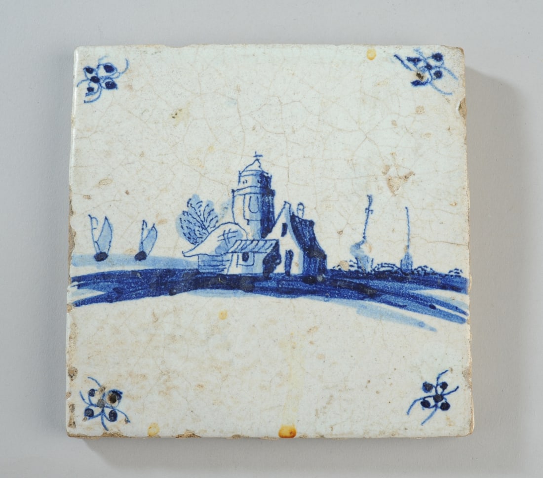 Dutch Delft Blue & White Tile, C.1680-1710: Amsterdam or Rotterdam. Waterside architectural landscape with domed tower and cluster of houses, boats on the horizon, "spinnekop" (spider head) corner motifs. Typical coarse biscuit back. Approx. 5"