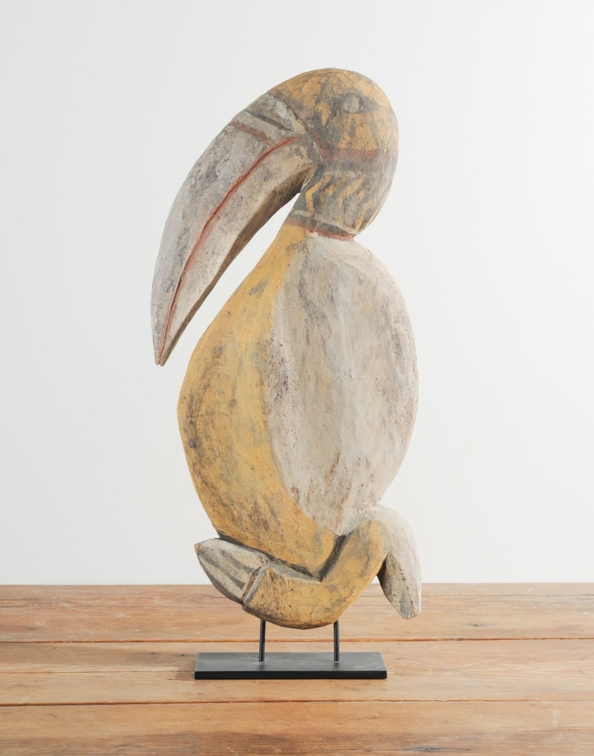 PNG Carved Abelam Bird: Oceana, Papua New Guinea, Abelam carved and painted wooden bird with huge curved bill. On gallery stand. Label from "Anderle, Primitive, Far-Eastern, Classic Art, Carmel-by-the-Sea" to bottom of stand