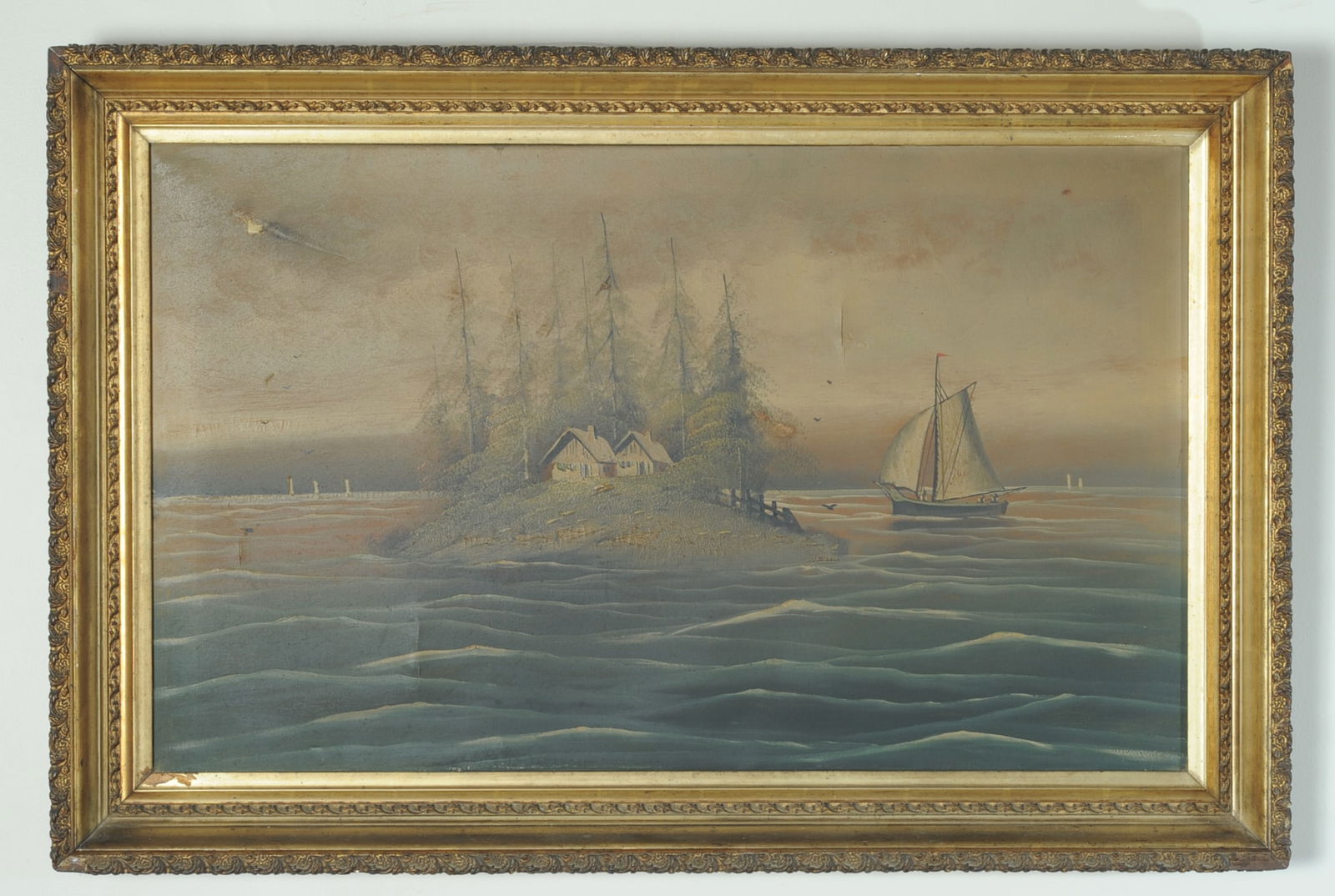 American or British School Coastal Landscape: Late 19th / early 20th century oil on canvas depicting a quiet coastal shoreline with cottages, marsh grasses, pilings, and a single sailboat in calm water, unsigned, some paint loss, old punctures an