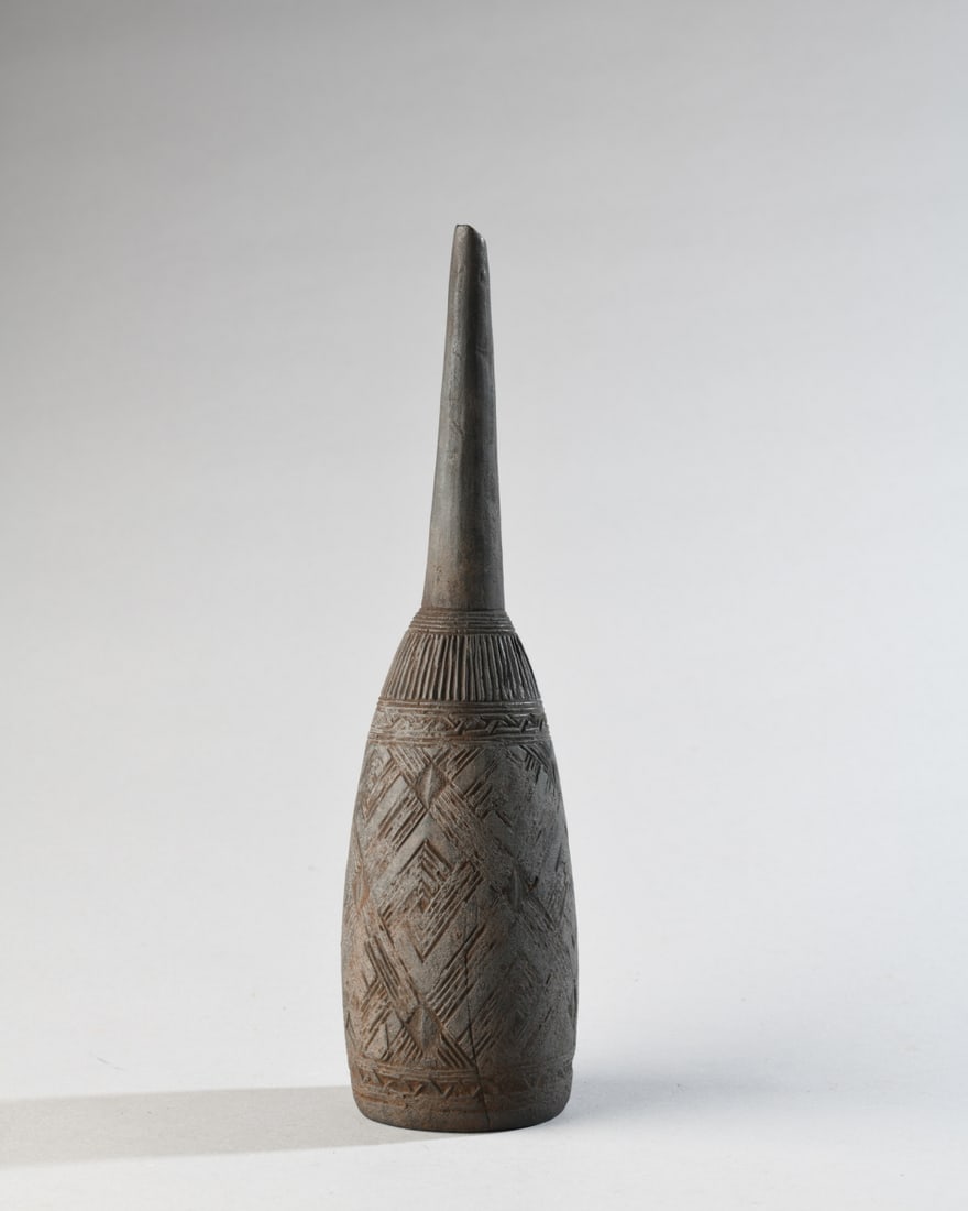 Kuba Ritual Clyster: Ornately carved wood ritual clyster / enema funnel, with all-over incised patterns reminiscent of Kuba textiles. Small chip at tip. Approx. 10" L. Our primary recommendation is to arrange shipping