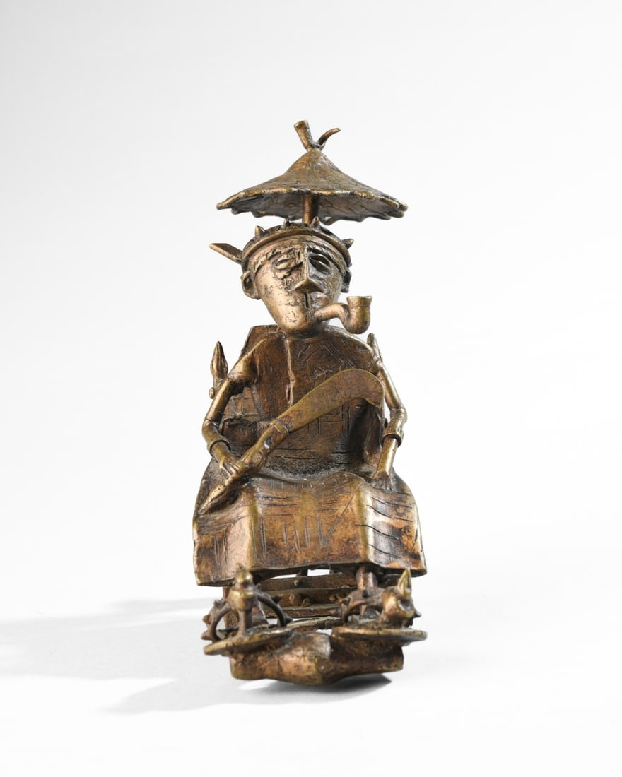 Ashanti / Akan Bronze Figure: Figure of an Ashanti king seated on his throne, a pipe in his mouth and a sword in his hand, a small boy behind him holding a parasol over the king's head. Approx. 7 1/4" H. Our primary recommendation