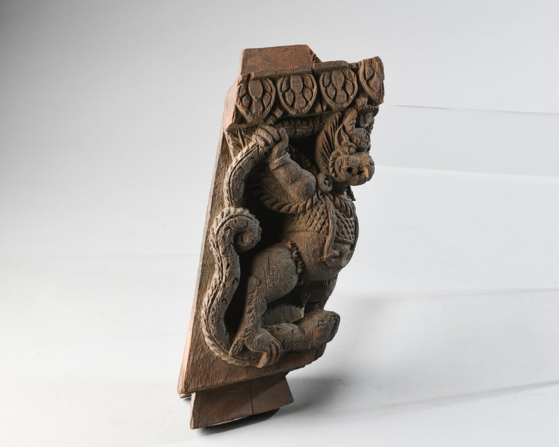 Carved Temple Figure, Nepal: Temple corner-piece with carved hardwood figure of Garuda, positioned grasping serpents with his hands and feet. Purchased in Katmandu in 1968. Approx.11" H. Our primary recommendation is to arrange