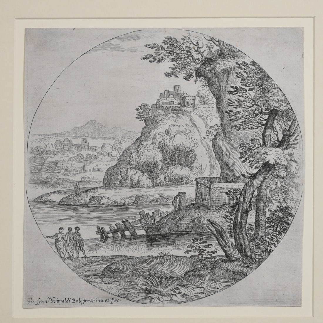 Giovanni Francesco Grimaldi (Bologna 1606–1680): Etching depicting a river landscape with three figures walking in the foreground, a fortified hilltop town beyond, and distant mountains across a broad valley. Signed in the plate, mounted with mat. T