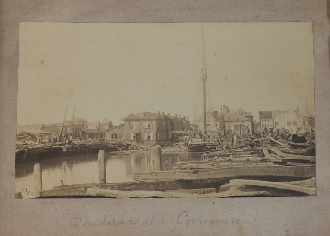 Albumen Photo Charleston Waterfront Damage: Albumen print photograph depicting Vanderhorst Wharf in Charleston, South Carolina, showing extensive damage to the waterfront district. The scene includes damaged buildings, scattered debris, and dis