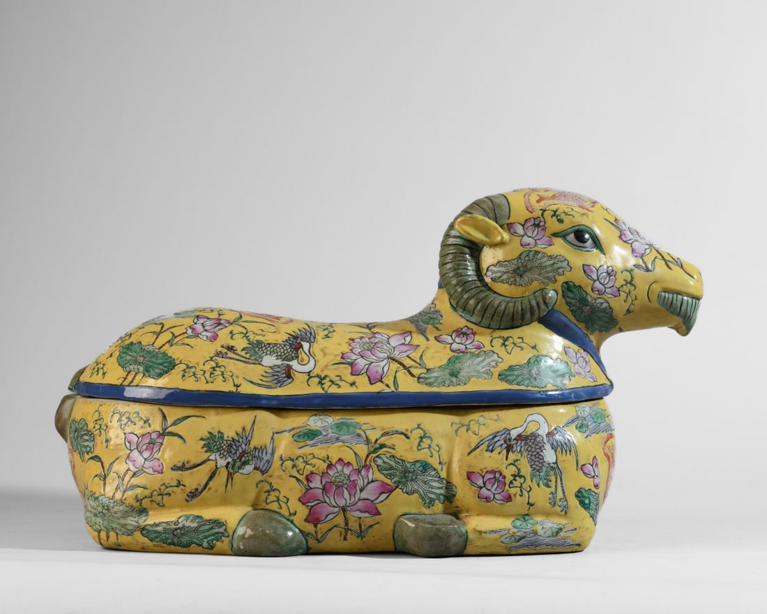 Chinese Ceramic Ram-Form Covered Box: Modeled as a recumbent ram with removable cover, the body decorated on a yellow ground with polychrome floral and figural motifs including cranes, fish, and lotus blossoms. Dimensions approx. 16" x 8