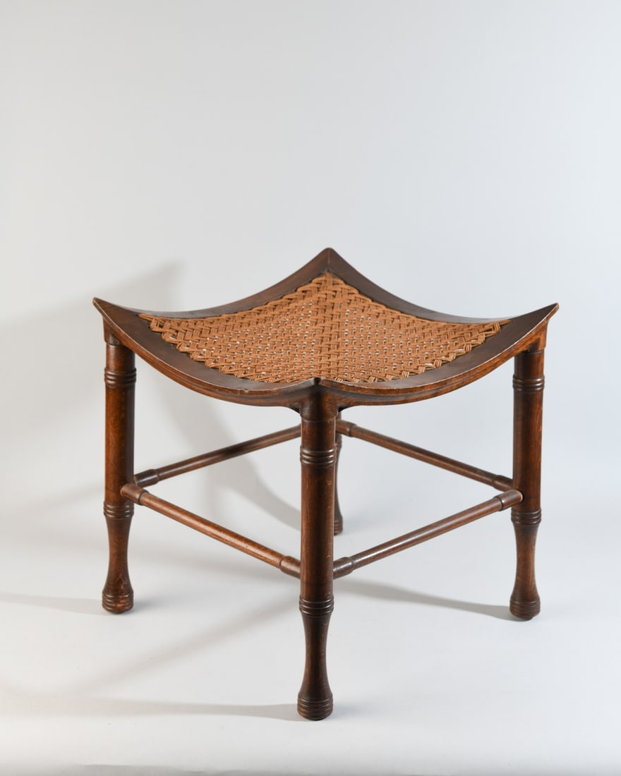 Late 19th/Early 20th C. Thebes Stool: Hardwood Thebes stool with woven cord seat, raised on turned legs with stretcher supports; minor wear, one stretcher slightly loose. Dimesnions approx. 15" x 14 1/2" x 14 1/2".Our primary