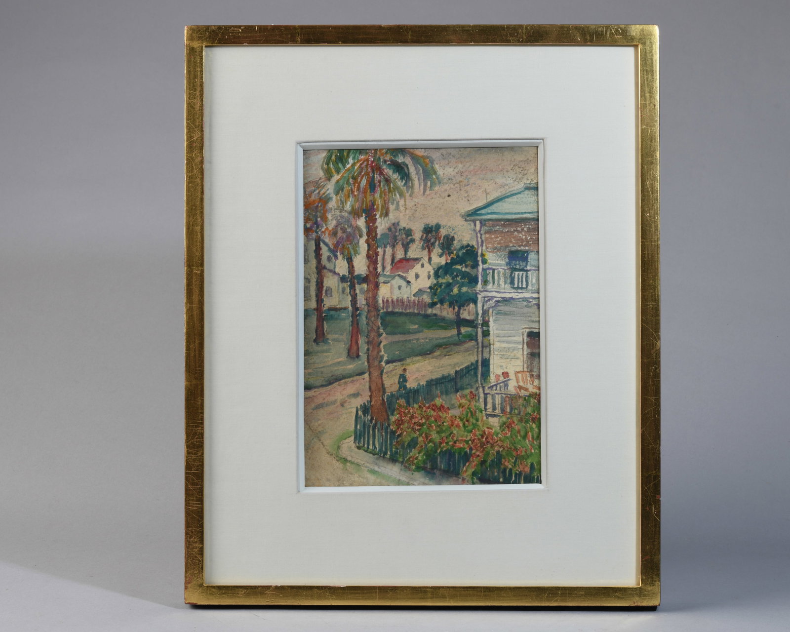 Charles H. Ebert (1873–1959) Watercolor: Key West Street Scene. watercolor on paper, not dated, depicting a palm-lined residential street with a veranda house and garden in the foreground; likely Florida subject. Matted and framed, backed wi