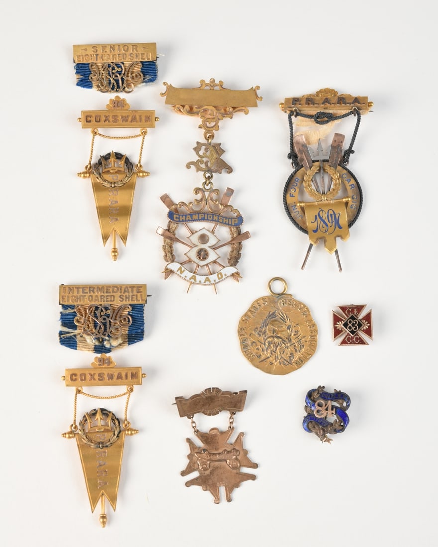 Mixed Group American Rowing & Athletic Medals: Nine medals and badges relating to late 19th / early 20th century rowing and athletic competitions, eight tested gold-plated, one with no gold, all in as-found condition.Our primary recommendation is