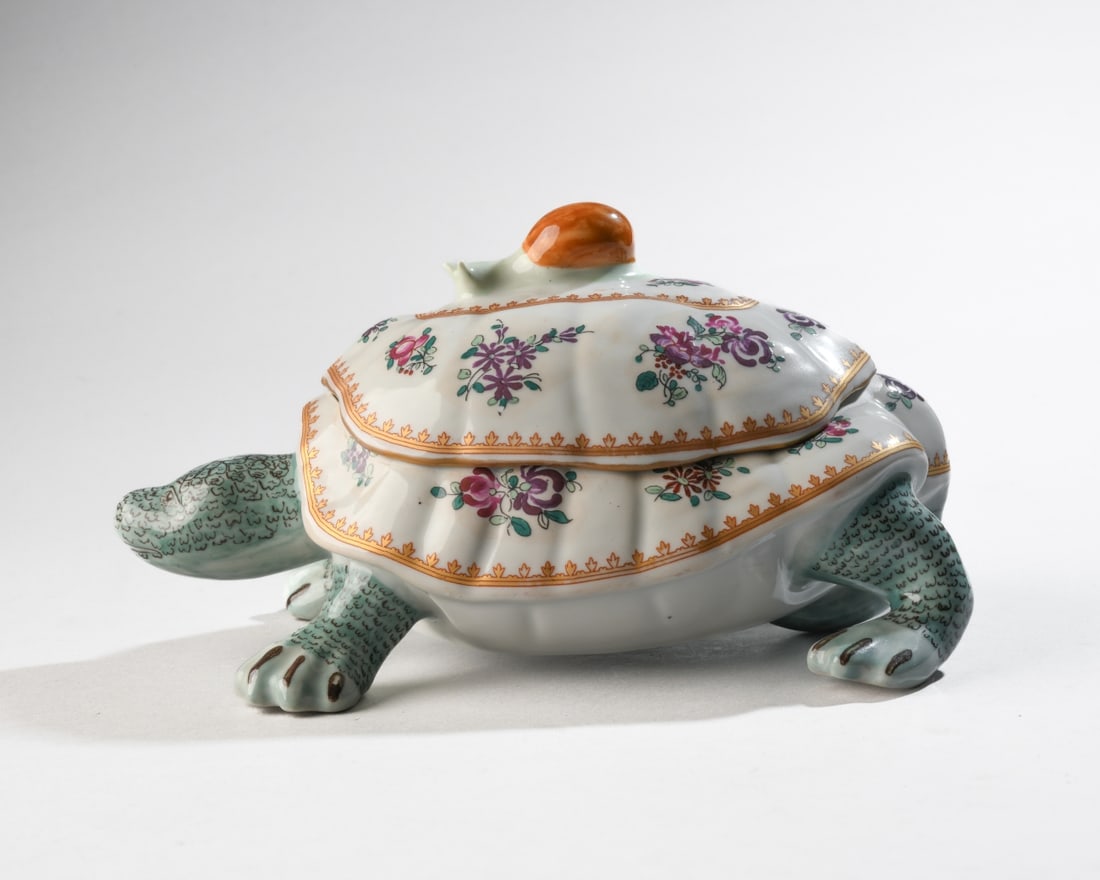 Continental Porcelain Turtle Form Covered Dish: Porcelain covered dish modeled as a turtle, the domed lid with a snail form finial. Decorated with hand painted floral sprays in pink, purple, and green, with gilt borders throughout. Marked to unders