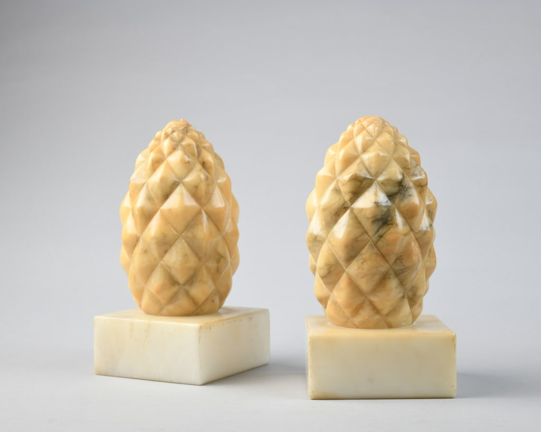 Pair Vintage Carved Alabaster Finials: Each carved in the form of a stylized pinecone with faceted surface, in warm honey-toned translucent alabaster, on square integral bases, 20th century, showing minor surface wear and scratching. H: