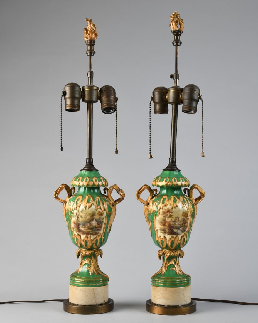 Pair of Continental Porcelain Urn Table Lamps: Baluster urn with twin scroll handles, polychrome enamel and gilt decoration on a green ground, reserves painted with pastoral landscape scenes and floral sprays, likely French (Paris porcelain), late