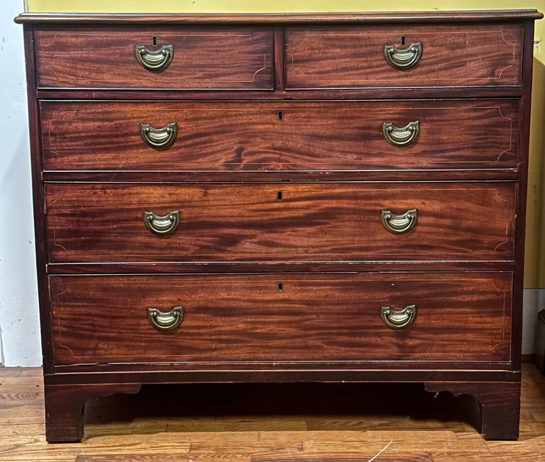 Late 18th C. English Neoclassical Chest of Drawers: Circa 1795, mahogany primary and oak secondary, molded edge top over two short dovetailed drawers with brass pulls over three longer drawers, bracket feet. H: approx. 37 1/4". W: approx. 43". D:
