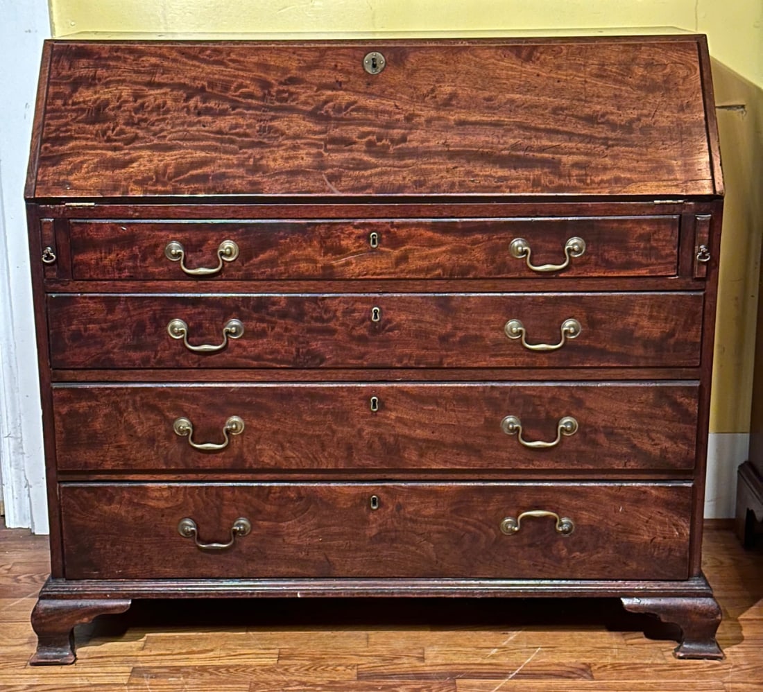 18th C. English Slant Front Desk: In San Domingo mahogany, with oak secondary, circa 1760, slant front opening to smaller drawers and pigeonholes over four graduated dovetailed drawers with brass pulls, bracket feet. Some minor