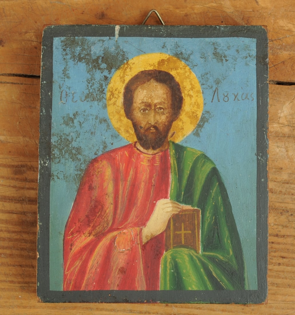 Small Painted Greek Icon, St. Lucas: Small hand painted icon showing St. Luke in red and green robes and carrying a book representing the Gospel according to St. Luke. Egg tempera on citrus or box wood. Approx. 3 1/4" x 4" x 5/8". Proven