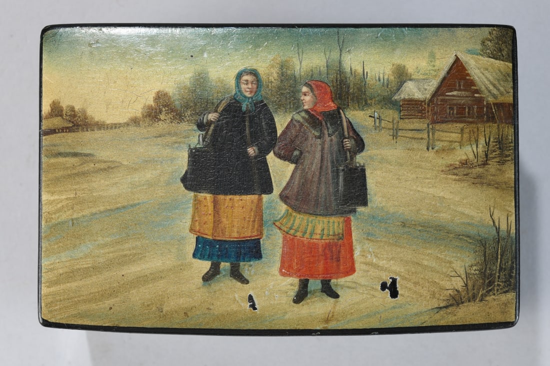 Lacquered Russian Box, Peasant Scene: Hinged lid, top decorated with image of two figures in traditional dress before a rural dwelling, the interior in brown lacquer, 20th century, surface with wear, craquelure, and losses. Dimensions