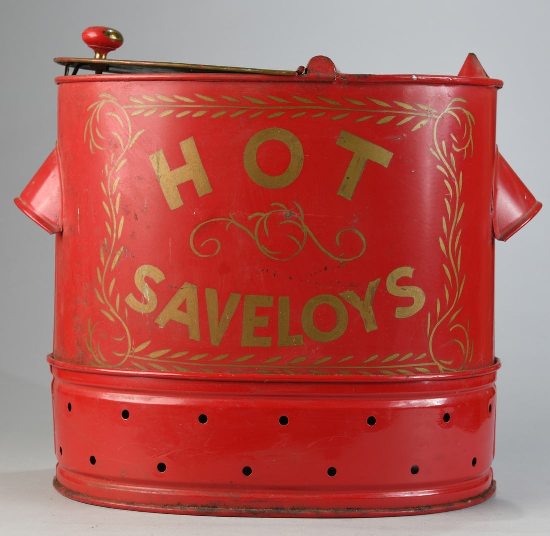 Painted Metal “Hot Saveloys?? Shop Warmer: Oval cylindrical sheet metal food warmer with hinged lid and knop handle, red-painted exterior with gilt stenciled “HOT SAVELoys” and foliate decoration, vented base and perforated interior tr