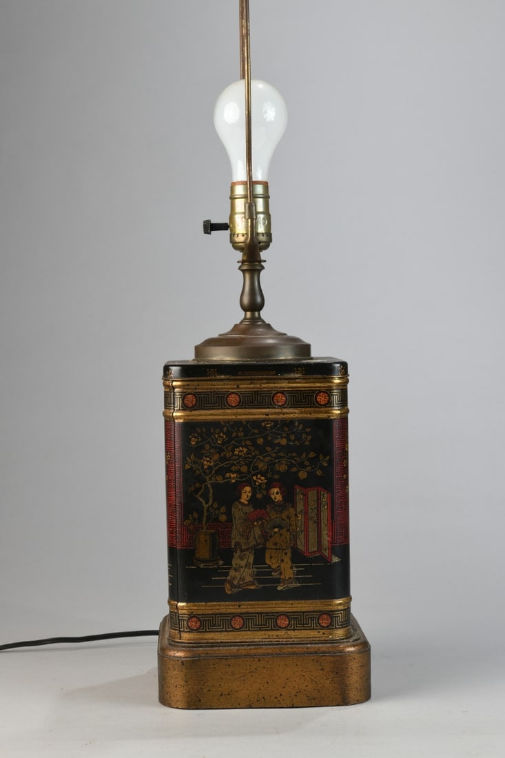 Chinoiserie-Decorated Tole Table Lamp: Rectangular painted tole lamp with wooden base, decorated in black ground with gilt and red chinoiserie scenes of figures in garden landscapes, bordered by geometric and foliate bands, likely European