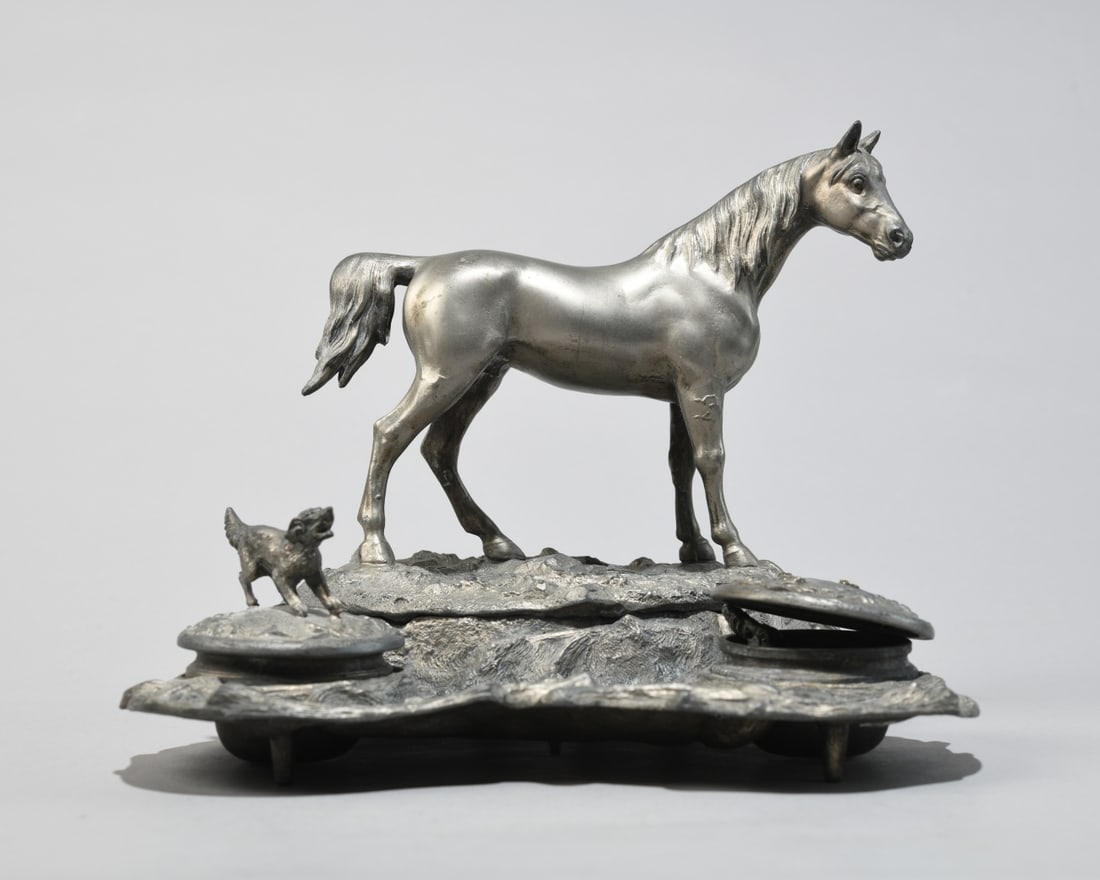 Figural Horse Double Ink Stand: Cast white metal figural desk set or inkstand, early 20th century, modeled with a standing horse atop a naturalistic base flanked by two lidded inkwells, each cover surmounted by a small dog (one brok