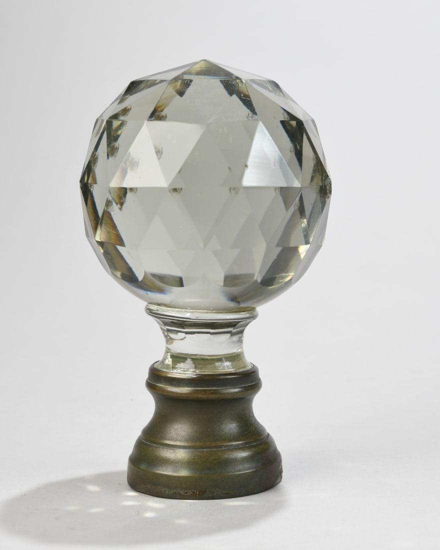 Cut Glass Finial: Faceted colorless glass spherical finial, likely late 19th to early 20th century, mounted to a turned metal base with warm patina. Several chips to glass. Dimensions approx. 6" x 3 1/2" x 3 1/2". Our 