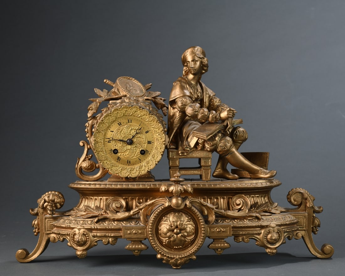 20th C. Figural Gilt Spelter Mantel Clock: Decorative clock modeled as a seated Renaissance-style figure beside a foliate-cast drum-form case with Roman numeral dial, the whole on an elaborate Rococo Revival base, base with visible crack and w