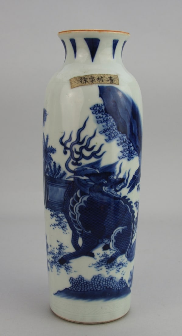 Chinese Blue and White Rouleau Vase: Chinese blue and white rouleau vase. Decorated with a Qilin and floral landscape. 10" high. Light wear. Our primary recommendation is to arrange shipping yourself using Blue Ridge Pack & Ship. Most bi