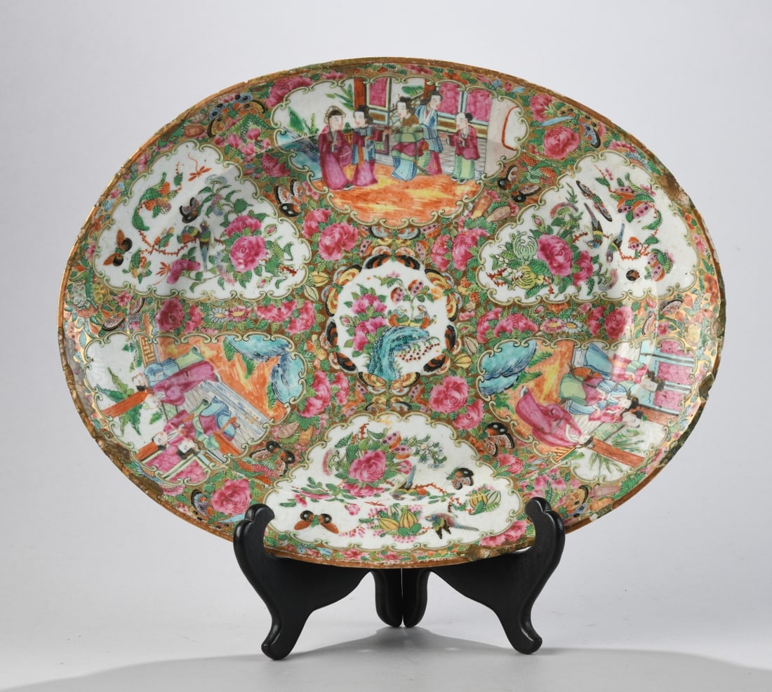 Chinese Export Porcelain Rose Medallion Platter: Oval porcelain serving platter with famille rose enamels and gilt decoration, Canton (Guangzhou), mid 19th century, the interior densely painted with alternating figural court scenes and bird-and-flow