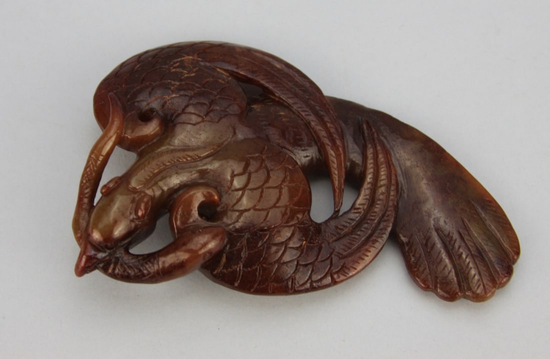 Chinese Carved Deep Cinnabar Red Jade Phoenix: Chinese carved deep cinnabar red jade phoenix. 6" long. Light wear. Our primary recommendation is to arrange shipping yourself using Blue Ridge Pack & Ship. Most bidders find this is the most economic