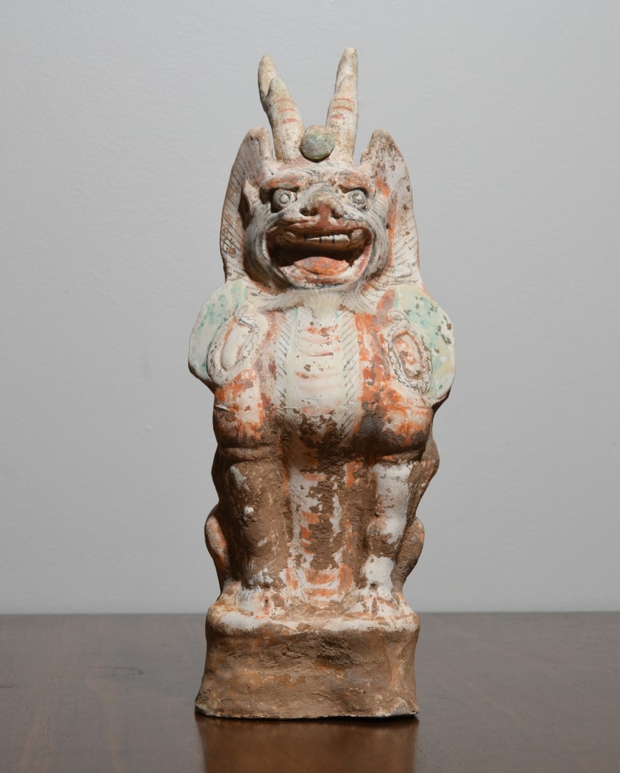 Chinese Earthenware Roof Ornament: Hollow-molded terracotta with traces of white slip and polychrome pigment, likely late Qing dynasty or later, depicting a horned, winged guardian creature with open mouth and incised details, weathere