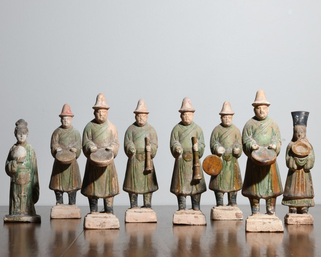 8 Chinese Ming Painted Pottery Tomb Figures: Group of eight Chinese painted pottery tomb figures, Ming Dynasty (1368–1644), comprising musicians and attendants, each modeled standing on a square plinth pierced with a circular vent hole, dresse