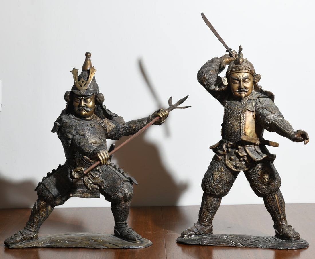 Two Bronze Sculptures of Japanese Warriors: Depicting samurai or warrior attendants in dynamic combat poses, probably 20th century, with one figure raising a short sword overhead and the other wielding a polearm, both wearing elaborately patter