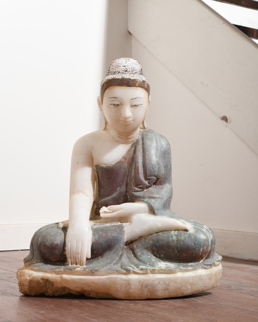 Carved Stone Seated Buddha: Southeast Asia, likely alabaster / calcite, 19th / 20th century, figure seated cross legged on an integral base, right hand extended to touch the earth, left hand in lap, wearing a robe draped over on