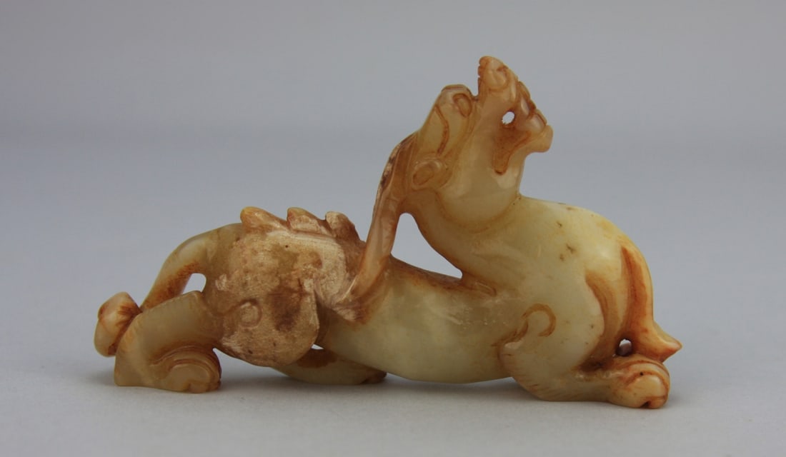 Chinese Carved Jade Mythical Beast: Chinese carved light celadon, white and russet jade figure of a mythical beast 4" long. Light wear. and calcification. Our primary recommendation is to arrange shipping yourself using Blue Ridge Pack 