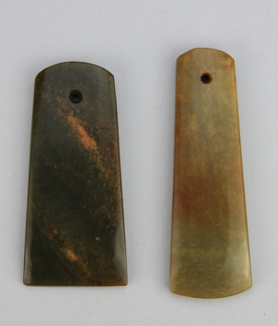 Two Chinese Carved Green Jade Axe Form Pendants: Two Chinese carved green jade axe form pendants. 3 3/4" and 4 1/2" long. Our primary recommendation is to arrange shipping yourself using Blue Ridge Pack & Ship. Most bidders find this is the most eco