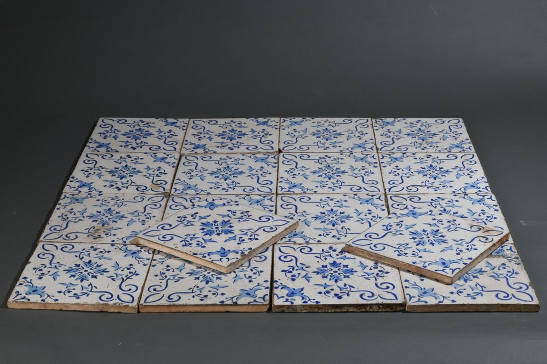 Eighteen Blue & White Earthenware Tiles: Glazed earthenware tiles decorated in dark and pale cobalt blue with a central foliate rosette and scrolling vinework, in the Iberian / Hispano-Moresque taste, likely late 19th to early 20th century. 