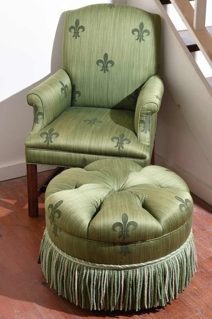Georgian Style Upholstered Armchair and Ottoman: 20th century, padded and scrolled arms, in green striped fabric with fleur-de-lis motif, on square mahogany legs. Together with matching tufted ottoman with bullion fringe. Minor wear/staining, condit