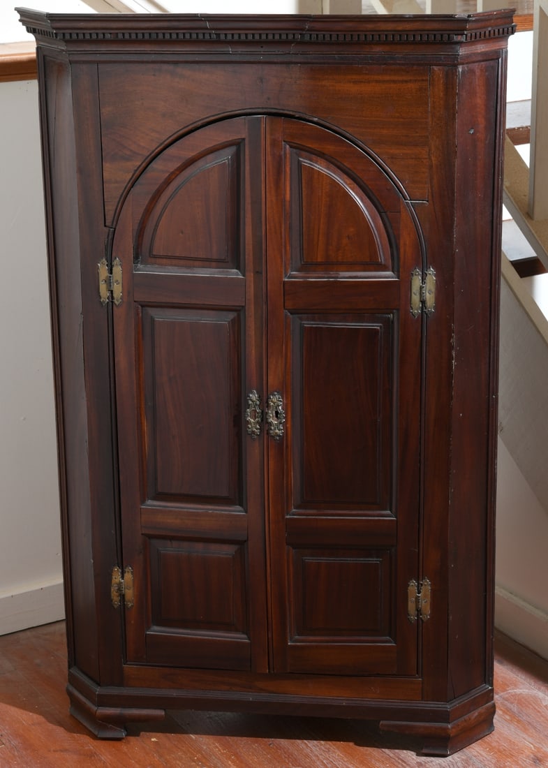 Antique English Diminutive Corner Cupboard: Mahogany primary with oak secondary, molded top over paneled doors opening to shaped shelves over three small drawers, bracket feet, some losses and damage. Dimensions approx. 53 1/2" H x 34" W x 20 1